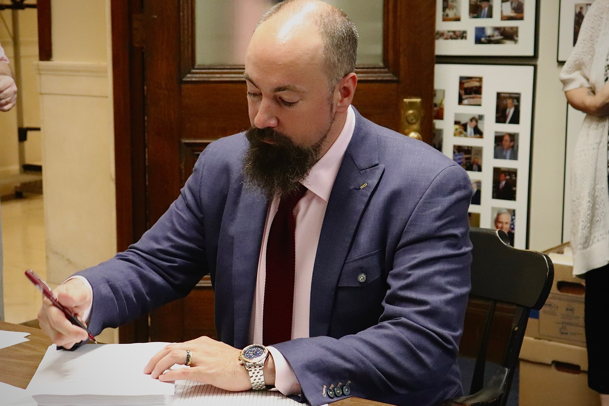 Jason Osborne signing legislation at the State House